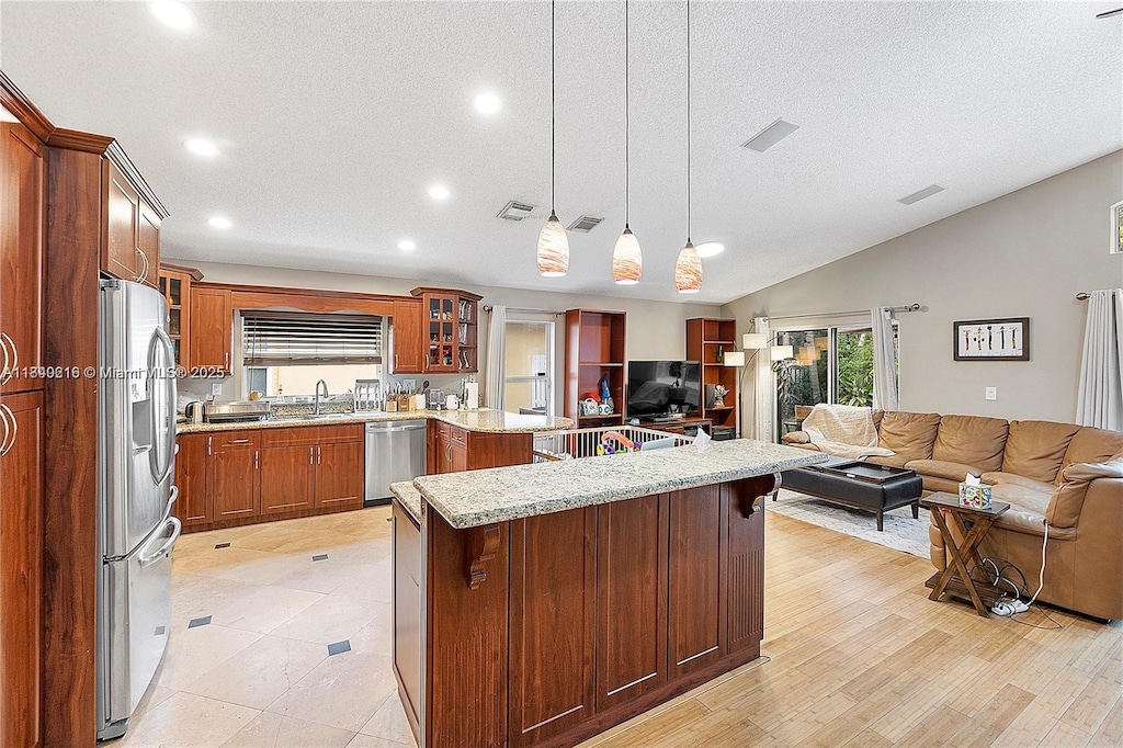 4945 SW 34th Ter, Hollywood, FL 33312 - kitchen featuring open floor plan, stainless steel appliances, glass insert cabinets, recessed lighting, and a kitchen breakfast bar