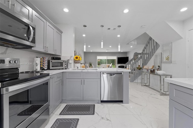 6348 Walk Cir, Boca Raton, FL 33433 - kitchen with appliances with stainless steel finishes, gray cabinets, a peninsula, light countertops, and recessed lighting