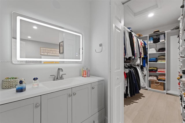 6348 Walk Cir, Boca Raton, FL 33433 - bathroom featuring vanity, a spacious closet, wood finished floors, and recessed lighting