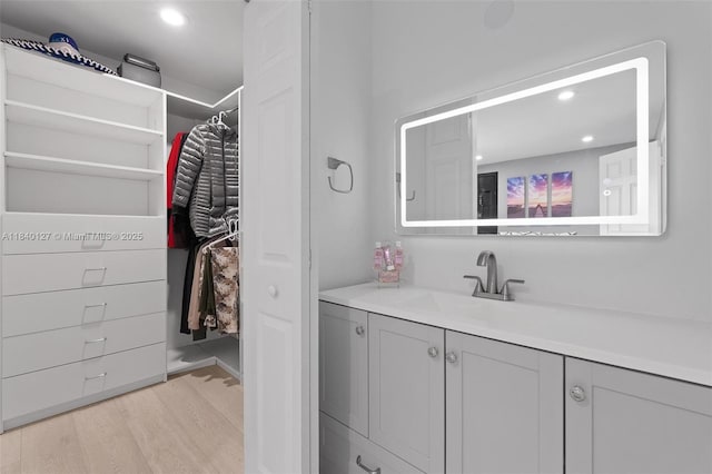 6348 Walk Cir, Boca Raton, FL 33433 - bathroom with vanity, wood finished floors, recessed lighting, and a walk in closet
