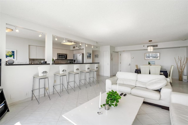 3530 Mystic Pointe Dr Unit 2014, Aventura, FL 33180 - living room with rail lighting and light tile patterned flooring