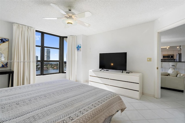 3530 Mystic Pointe Dr Unit 2014, Aventura, FL 33180 - bedroom featuring refrigerator, a textured ceiling, tile patterned floors, and a ceiling fan