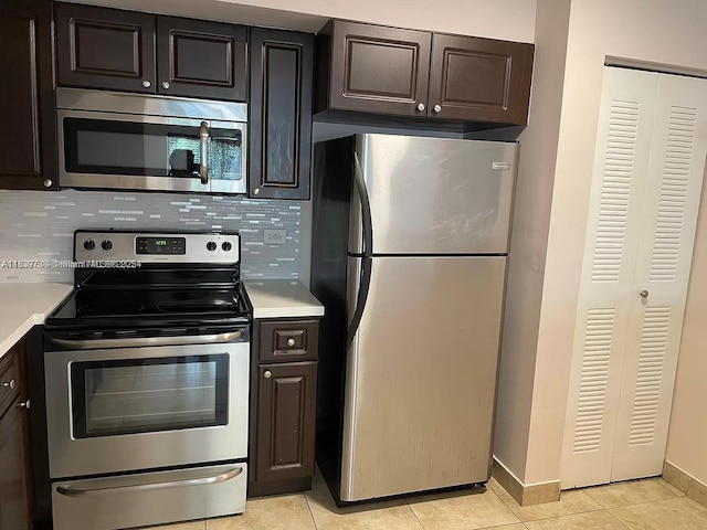 3690 N 56th Ave Unit 916, Hollywood, FL 33021 - kitchen featuring stainless steel appliances, light countertops, tasteful backsplash, and light tile patterned floors