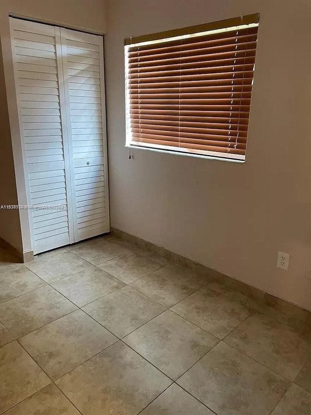 3690 N 56th Ave Unit 916, Hollywood, FL 33021 - unfurnished bedroom featuring tile patterned flooring and a closet