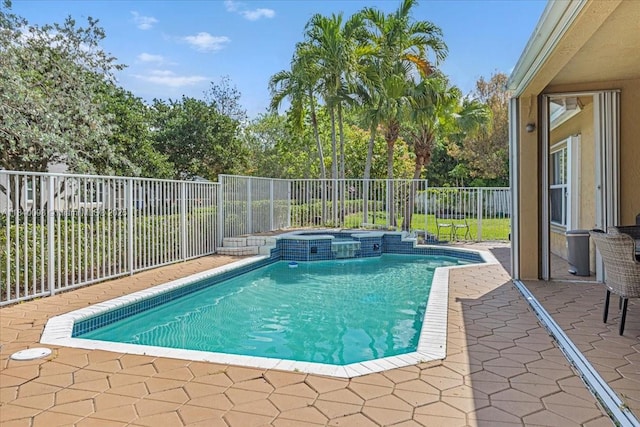 13063 NW 11th Ct, Sunrise, FL 33323 - view of swimming pool with a pool with connected hot tub, a patio, and a fenced backyard