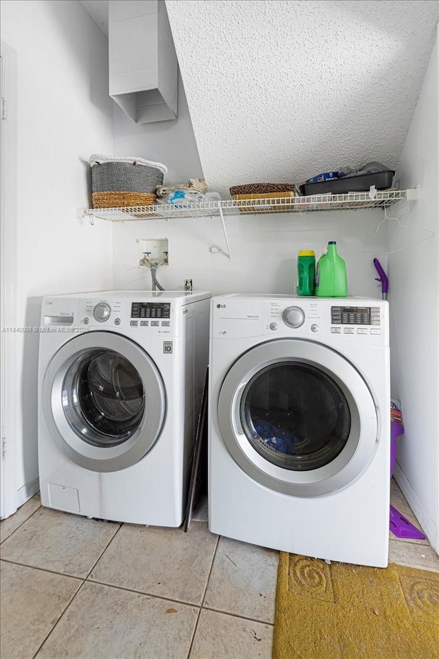 13063 NW 11th Ct, Sunrise, FL 33323 - washroom with washer and clothes dryer, light tile patterned floors, and a textured ceiling