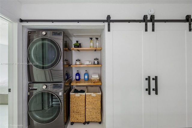 16479 NE 27th Pl Unit 16, North Miami Beach, FL 33160 - washroom with stacked washer / dryer and a barn door