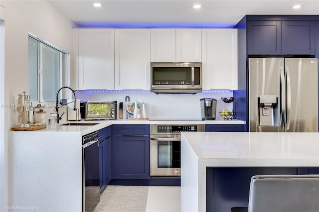 16479 NE 27th Pl Unit 16, North Miami Beach, FL 33160 - kitchen featuring appliances with stainless steel finishes, white cabinetry, and recessed lighting