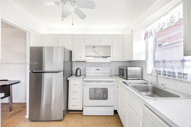 5300 Washington St Unit Q207, Hollywood, FL 33021 - kitchen with stainless steel appliances, under cabinet range hood, white cabinets, and light countertops