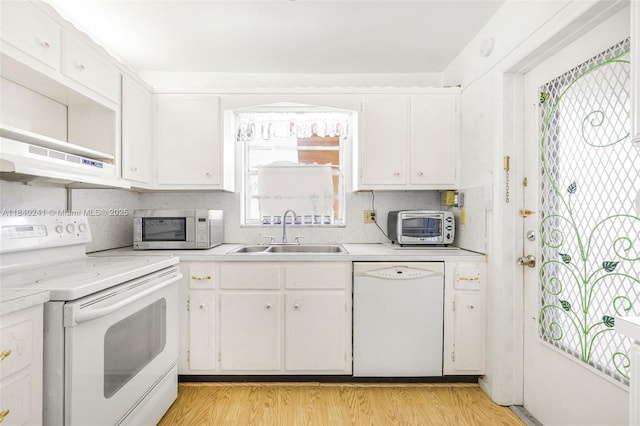 5300 Washington St Unit Q207, Hollywood, FL 33021 - kitchen featuring white appliances, light countertops, ventilation hood, and white cabinetry