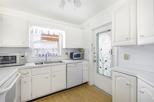 5300 Washington St Unit Q207, Hollywood, FL 33021 - kitchen featuring white appliances, light countertops, white cabinetry, and light wood-style flooring