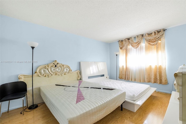 5300 Washington St Unit Q207, Hollywood, FL 33021 - bedroom with light wood-type flooring and a textured ceiling
