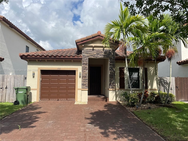 730 SE 34th Ave, Homestead, FL 33033 - mediterranean / spanish home featuring stucco siding, a garage, a tile roof, and decorative driveway