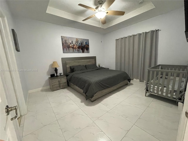730 SE 34th Ave, Homestead, FL 33033 - bedroom with light marble finish floors, a tray ceiling, and ceiling fan