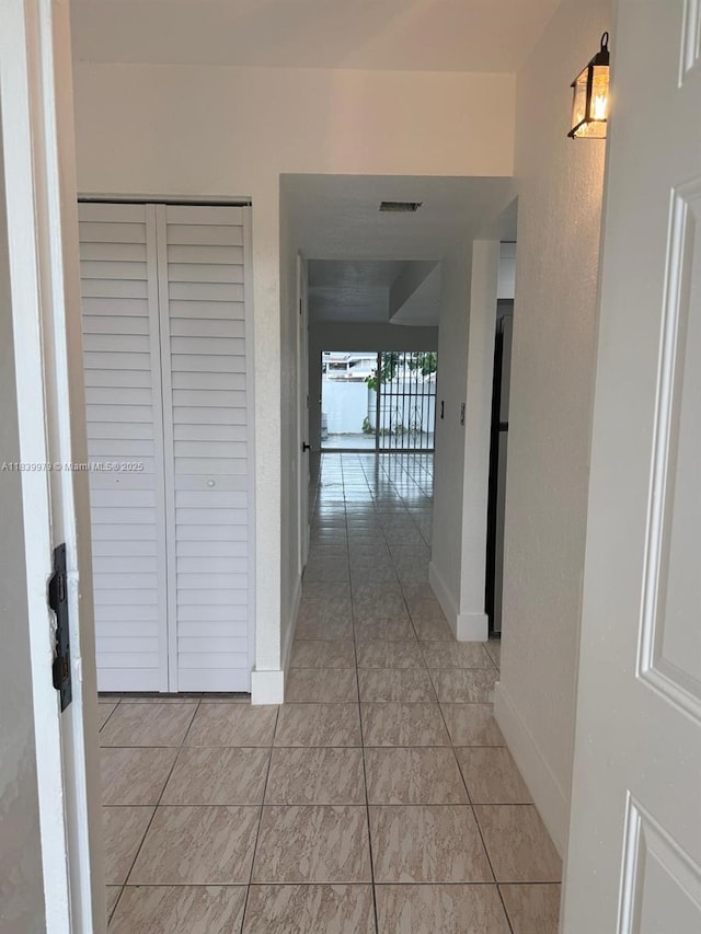 3860 W 11th Ln, Hialeah, FL 33012 - hallway with baseboards and light tile patterned floors