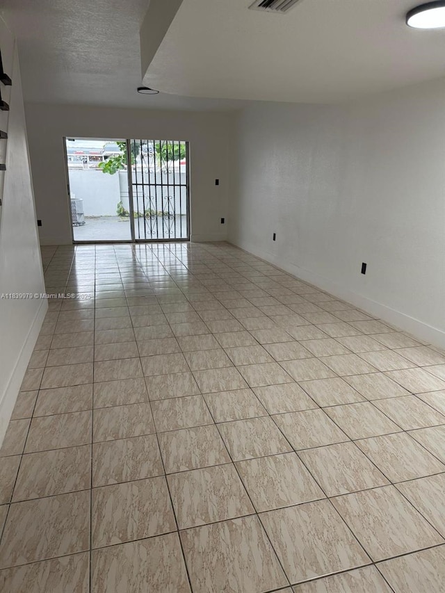 3860 W 11th Ln, Hialeah, FL 33012 - empty room with baseboards and light tile patterned floors