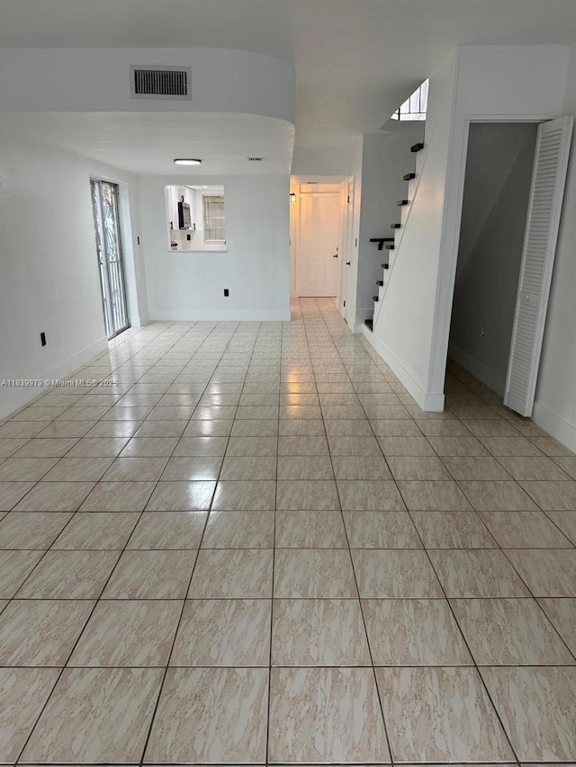 3860 W 11th Ln, Hialeah, FL 33012 - unfurnished living room with stairway and light tile patterned floors