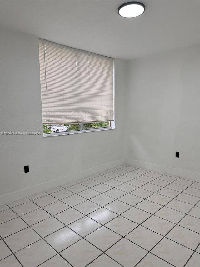 3860 W 11th Ln, Hialeah, FL 33012 - empty room with baseboards and light tile patterned floors
