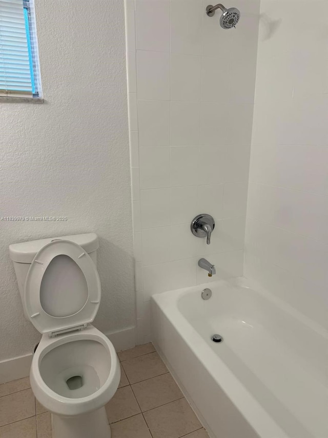 3860 W 11th Ln, Hialeah, FL 33012 - full bathroom featuring tile patterned floors, bathtub / shower combination, and a textured wall