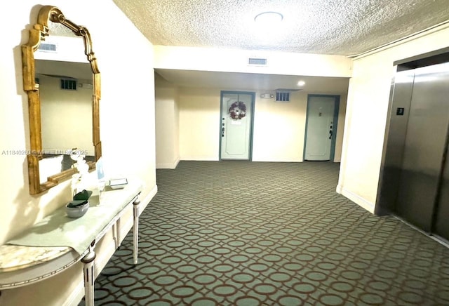 6911 SW 147th Ave Unit 3C, Miami, FL 33193 - hall featuring a textured ceiling, elevator, and dark carpet