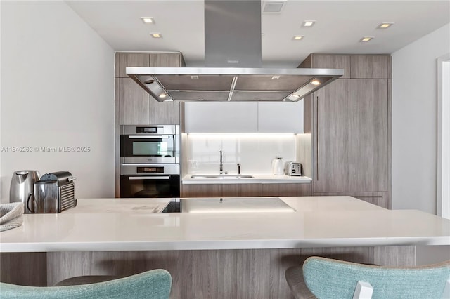 360 Ocean Dr Unit 704S, Key Biscayne, FL 33149 - kitchen with island range hood, modern cabinets, a breakfast bar, and stainless steel double oven