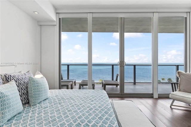 360 Ocean Dr Unit 704S, Key Biscayne, FL 33149 - bedroom featuring expansive windows, a water view, multiple windows, wood finished floors, and recessed lighting
