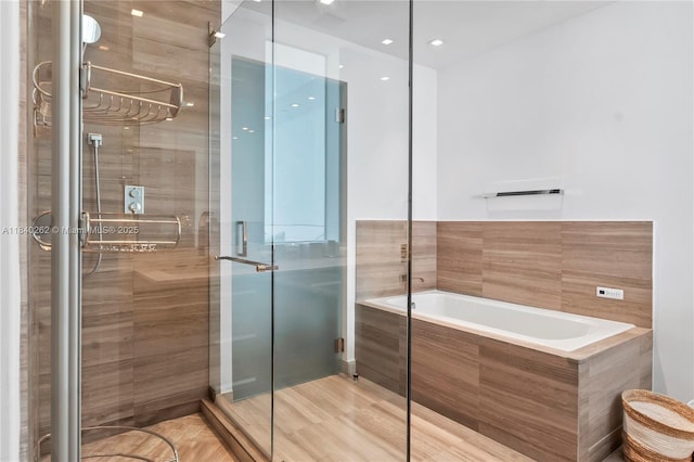 360 Ocean Dr Unit 704S, Key Biscayne, FL 33149 - bathroom with a bath, a shower stall, and wood finished floors