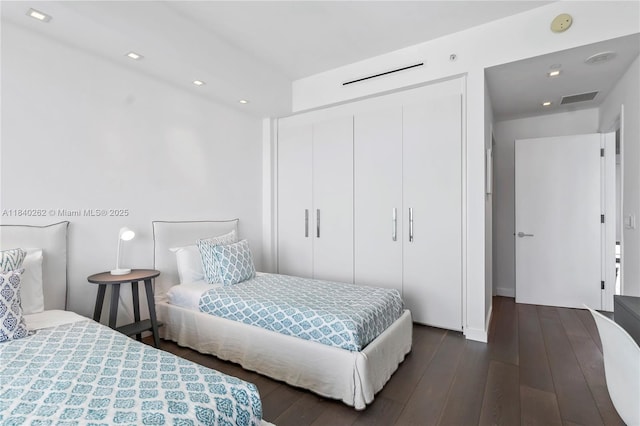 360 Ocean Dr Unit 704S, Key Biscayne, FL 33149 - bedroom featuring a closet, dark wood-type flooring, and recessed lighting