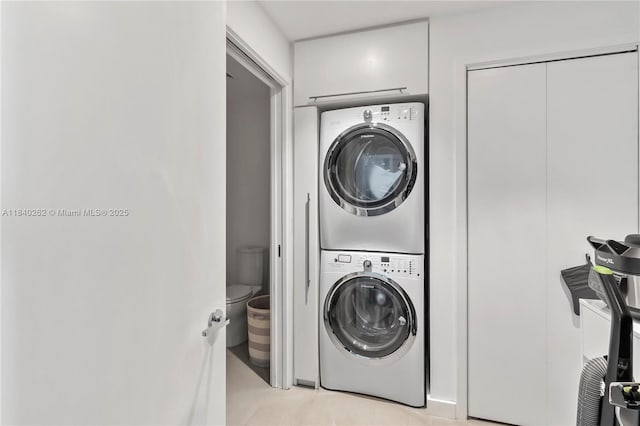 360 Ocean Dr Unit 704S, Key Biscayne, FL 33149 - laundry area with stacked washing machine and dryer and light tile patterned floors