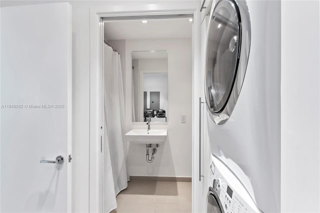 360 Ocean Dr Unit 704S, Key Biscayne, FL 33149 - laundry room with stacked washer / drying machine and light tile patterned floors
