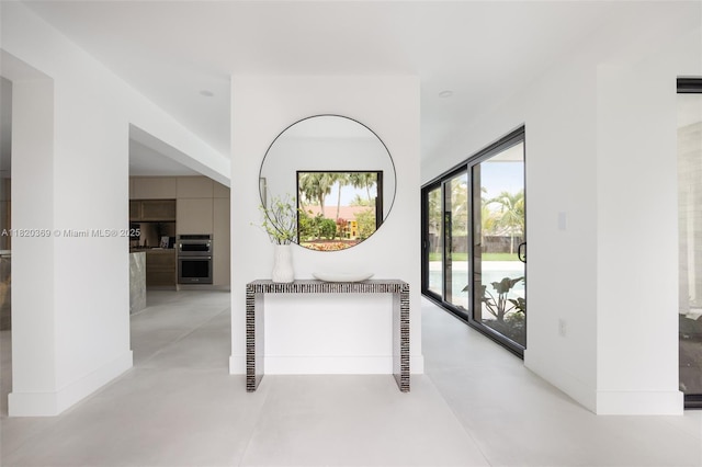7805 SW 165th St, Palmetto Bay, FL 33157 - corridor featuring finished concrete floors and baseboards