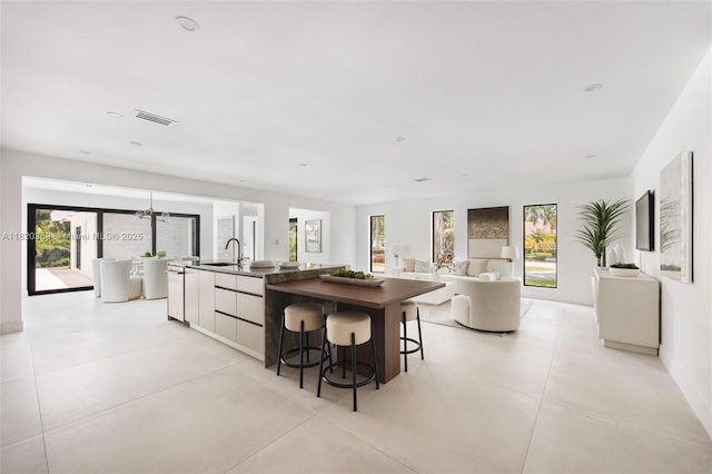 7805 SW 165th St, Palmetto Bay, FL 33157 - kitchen with dark countertops, a large island, plenty of natural light, and modern cabinets