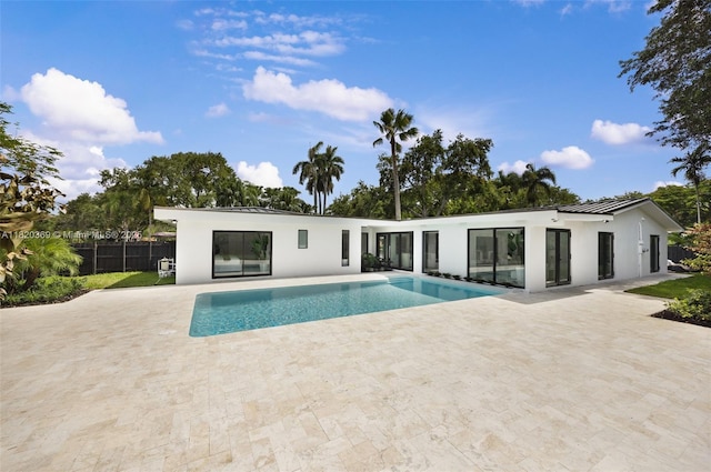 7805 SW 165th St, Palmetto Bay, FL 33157 - rear view of property with stucco siding, a patio, and a standing seam roof