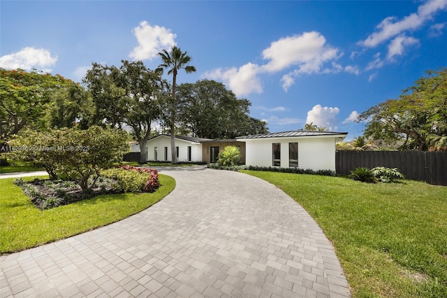 7805 SW 165th St, Palmetto Bay, FL 33157 - view of front of home with curved driveway, a standing seam roof, stucco siding, and a metal roof