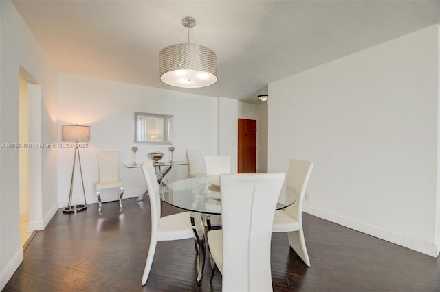 3801 S Ocean Dr Unit 5L, Hollywood, FL 33019 - dining area with dark wood-style flooring and baseboards