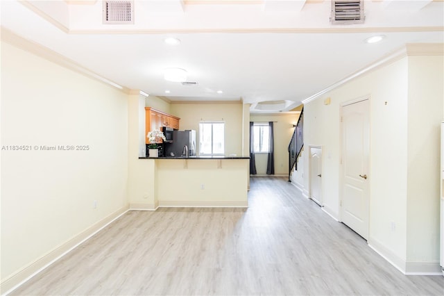 11647 NE 18th Dr Unit 11647, North Miami, FL 33181 - kitchen with stainless steel fridge, crown molding, dark countertops, a peninsula, and light wood-type flooring