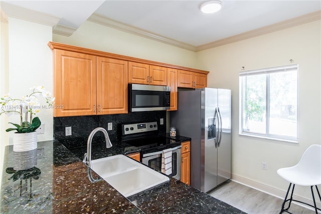 11647 NE 18th Dr Unit 11647, North Miami, FL 33181 - kitchen featuring stainless steel appliances, crown molding, decorative backsplash, brown cabinetry, and light wood-style floors