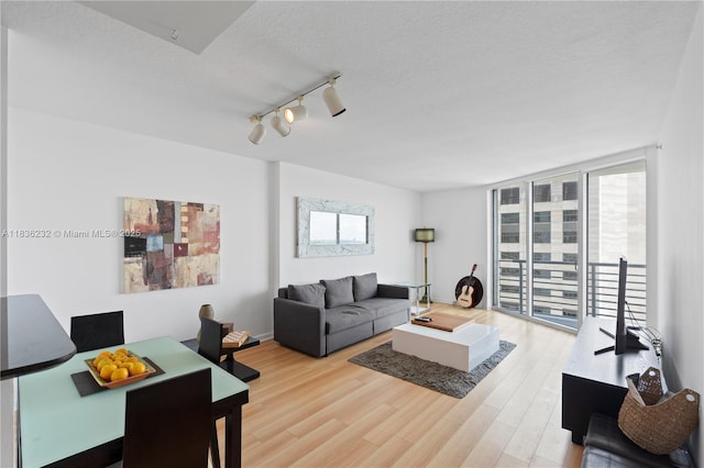 335 S Biscayne Blvd Unit 3410, Miami, FL 33131 - living room with track lighting, wood finished floors, and a textured ceiling