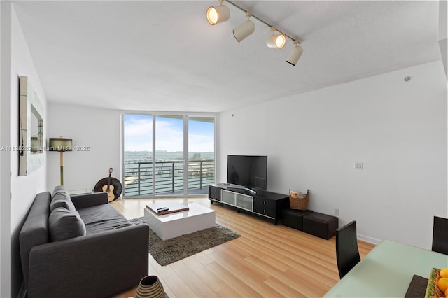 335 S Biscayne Blvd Unit 3410, Miami, FL 33131 - living room featuring expansive windows, light wood-type flooring, and track lighting
