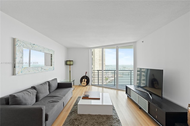 335 S Biscayne Blvd Unit 3410, Miami, FL 33131 - living area with healthy amount of natural light, light wood finished floors, and a wall of windows
