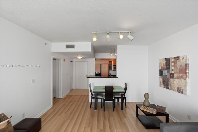 335 S Biscayne Blvd Unit 3410, Miami, FL 33131 - dining space with light wood-style flooring and baseboards
