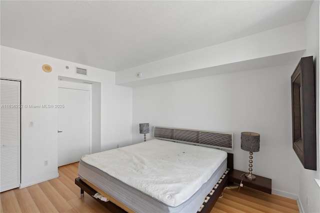 335 S Biscayne Blvd Unit 3410, Miami, FL 33131 - bedroom with light wood-style flooring