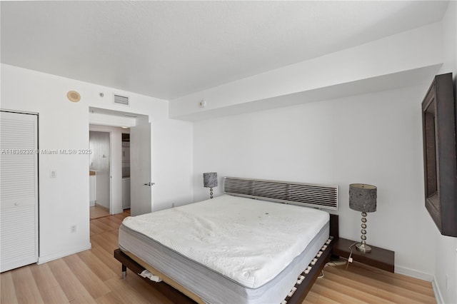 335 S Biscayne Blvd Unit 3410, Miami, FL 33131 - bedroom with light wood-style flooring