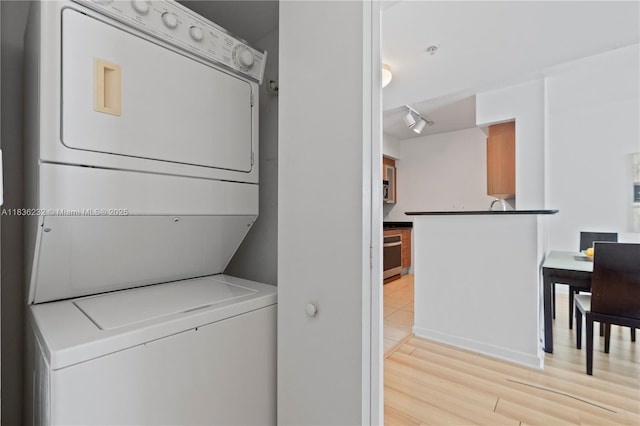 335 S Biscayne Blvd Unit 3410, Miami, FL 33131 - washroom featuring stacked washer / dryer and light wood-style floors