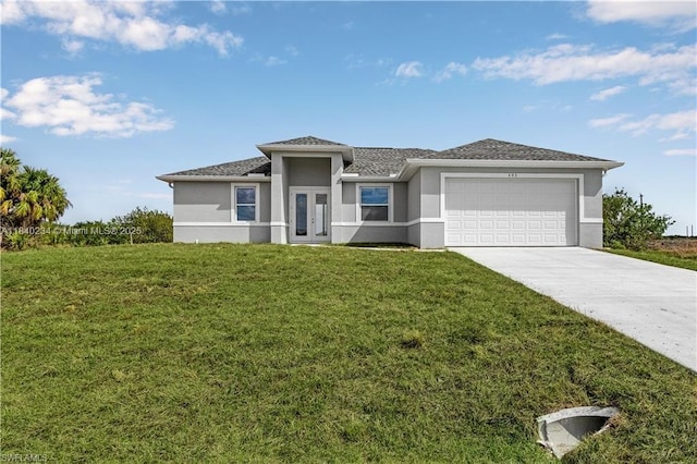 131 N Bethlehem Pl, La Belle, FL 33935 - prairie-style house with stucco siding, concrete driveway, an attached garage, french doors, and a front lawn