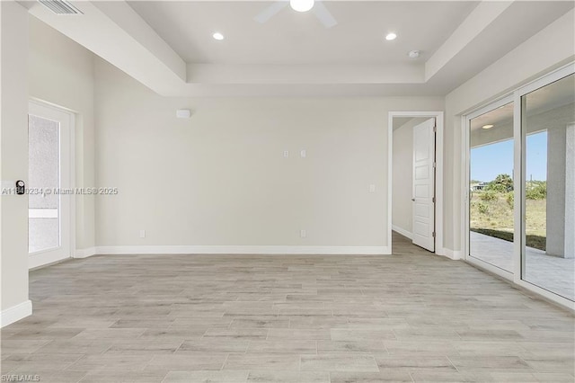 131 N Bethlehem Pl, La Belle, FL 33935 - empty room featuring a tray ceiling, light wood-type flooring, a ceiling fan, and recessed lighting