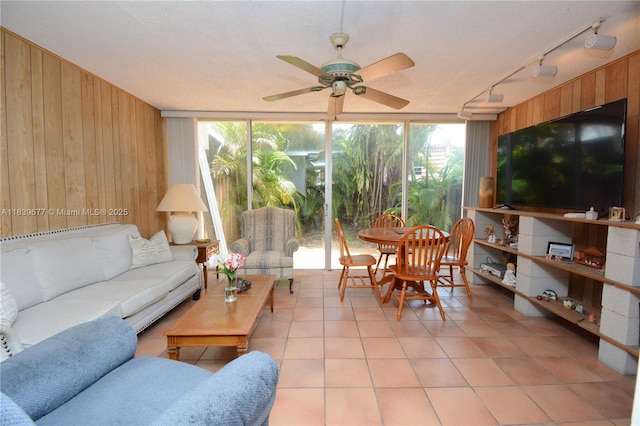 13935 SW 84th St Unit 905, Miami, FL 33183 - living area featuring track lighting, wood walls, healthy amount of natural light, light tile patterned floors, and a ceiling fan