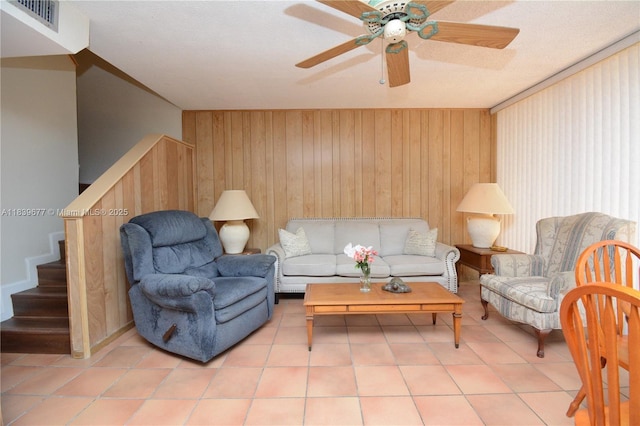 13935 SW 84th St Unit 905, Miami, FL 33183 - living room with stairs, a ceiling fan, light tile patterned floors, and wood walls