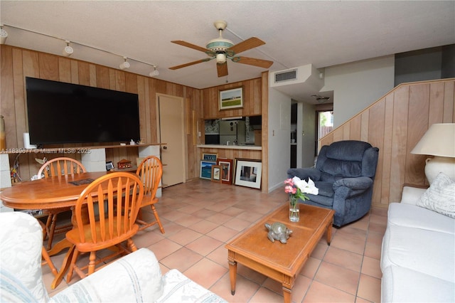 13935 SW 84th St Unit 905, Miami, FL 33183 - living area featuring wooden walls, rail lighting, ceiling fan, and light tile patterned floors