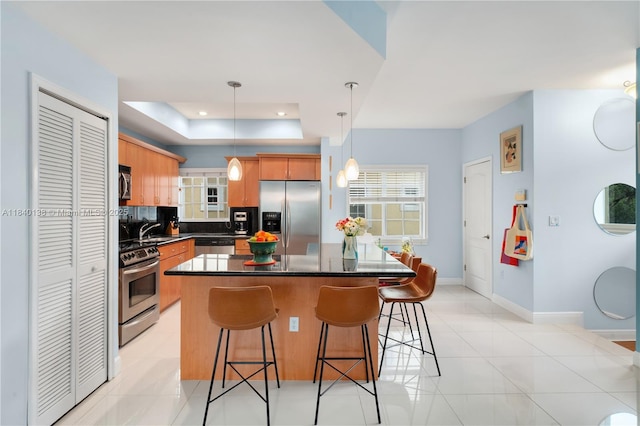 2919 Coconut Ave Unit 1, Miami, FL 33133 - kitchen featuring stainless steel appliances, dark countertops, a center island, a kitchen breakfast bar, and recessed lighting